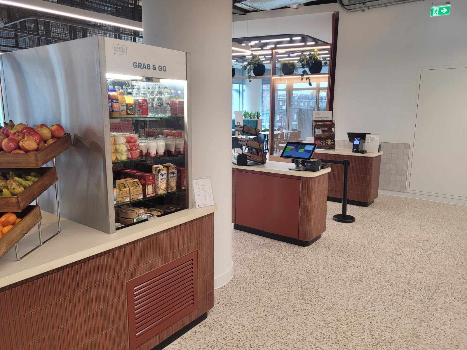 Custom-built service counter with engineered stone top and weatherboard frontage at Equinor's Paddington office, featuring designated areas for traditional plated service and live cooking.