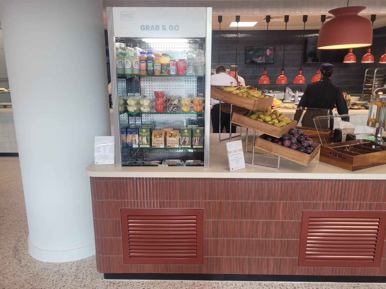 Back-to-back ambient display cases and chilled multidecks installed at Equinor's London headquarters, showcasing beverages and merchandise.
