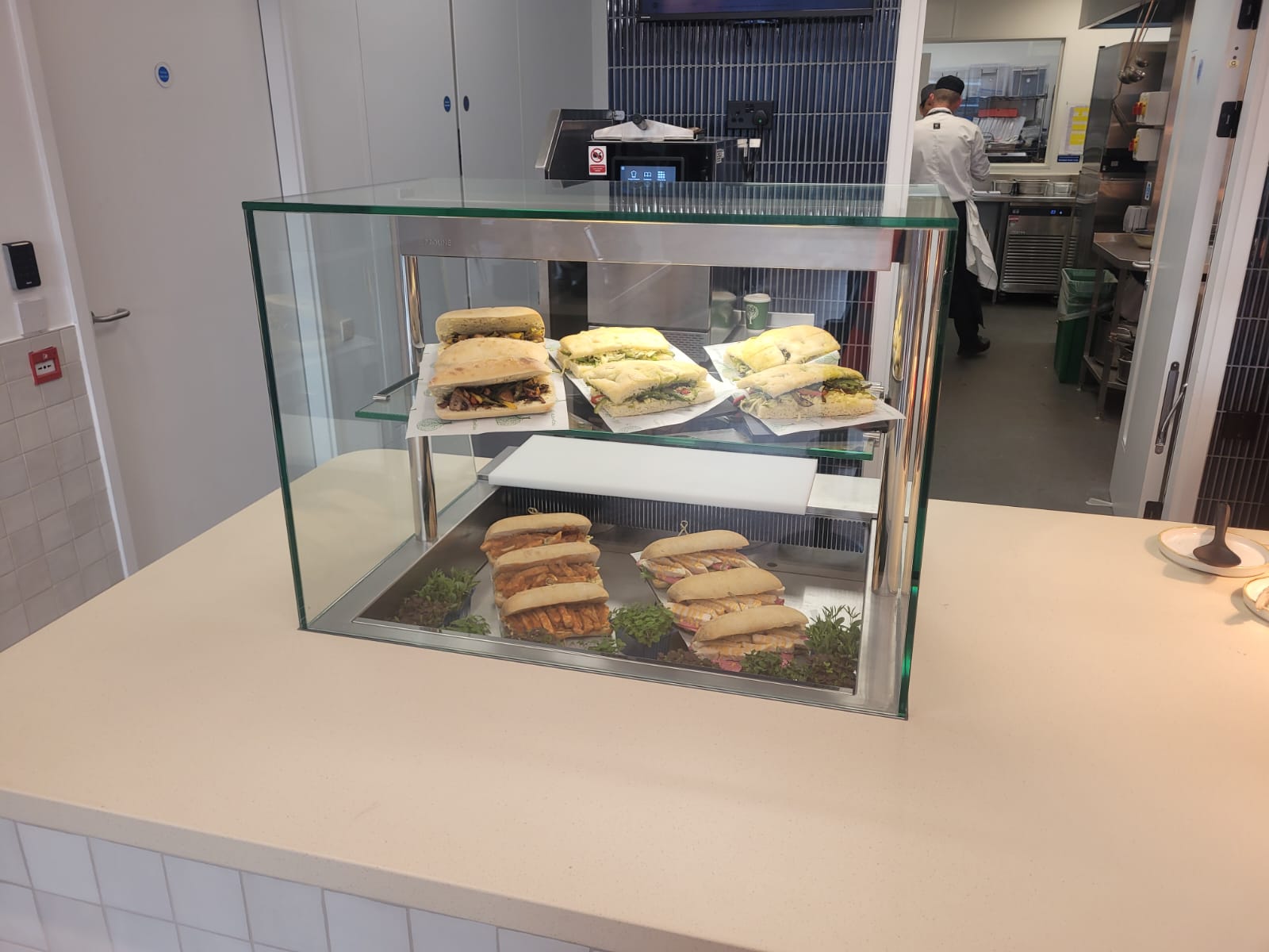 Back-to-back ambient display cases and chilled multidecks installed at Equinor's London headquarters, showcasing beverages and merchandise.
