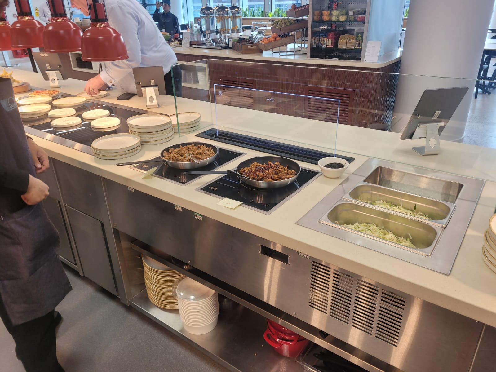 Back-to-back ambient display cases and chilled multidecks installed at Equinor's London headquarters, showcasing beverages and merchandise.
